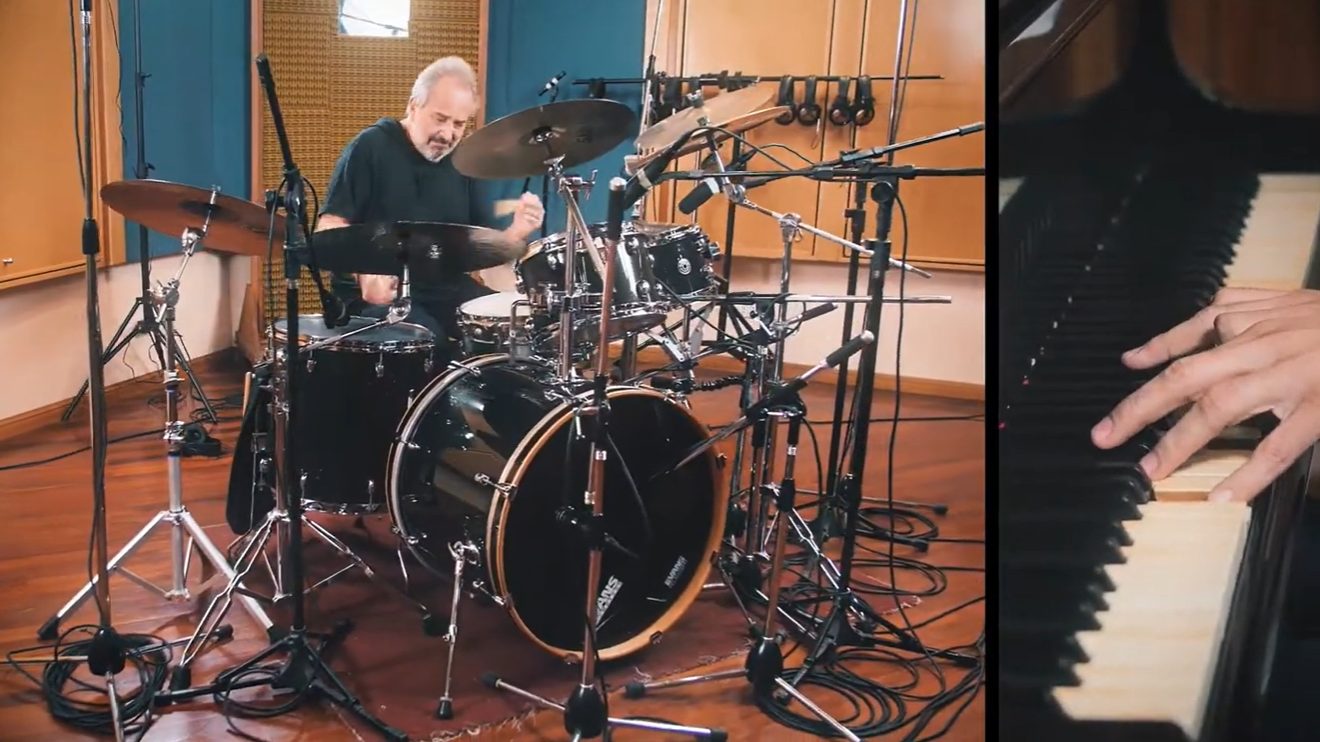 Luis Ceravolo at the drums in the studio, beside a close-up of hands on the piano, in the Libertango video