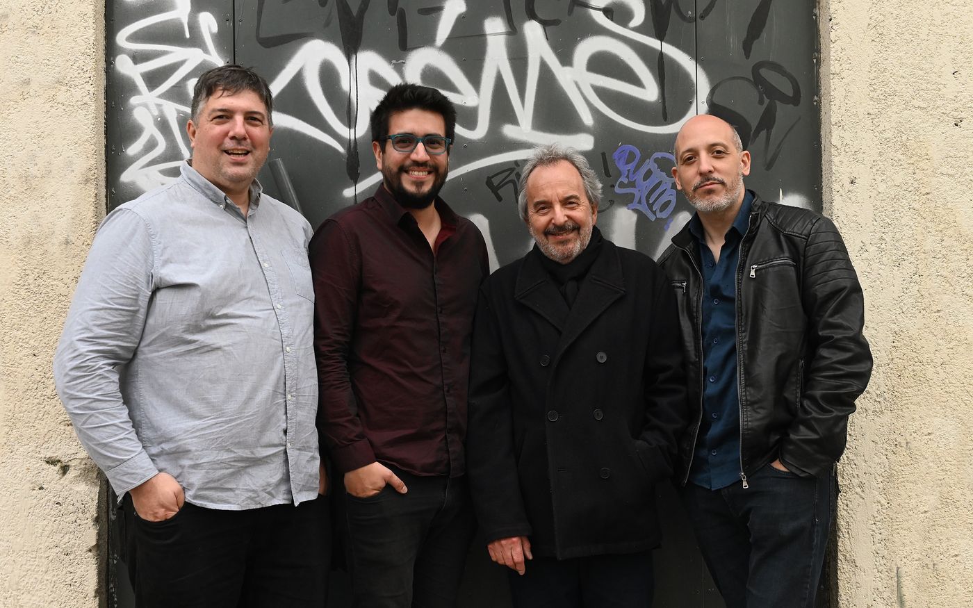 Luis Ceravolo 4 in front of a graffiti-covered door. From left: Juan Pablo Navarro, Nicolás Enrich, Luis Ceravolo and Cristian Zárate.