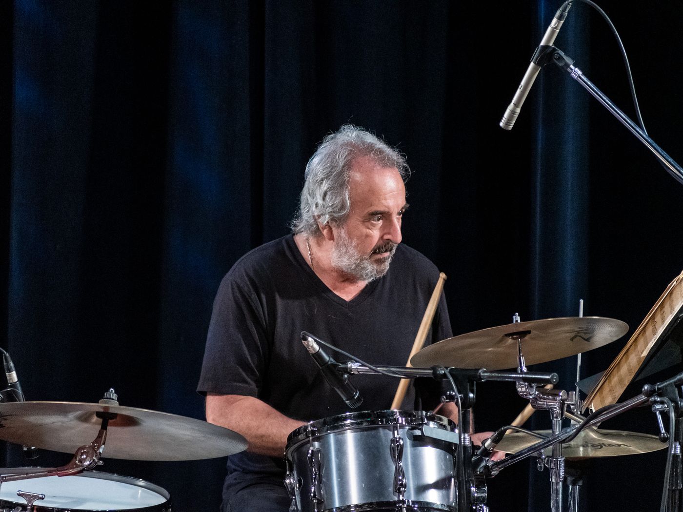 Luis Ceravolo at the drums, reading a chart on the music stand