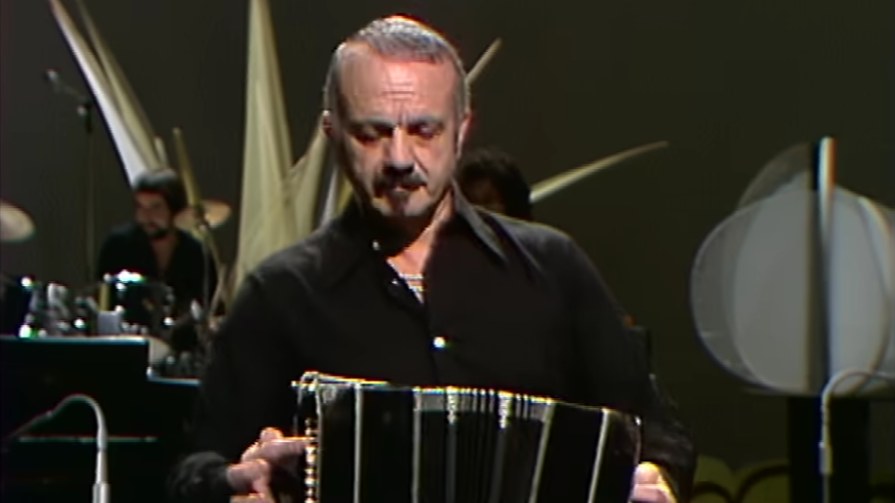 Astor Piazzolla playing the bandoneon with his Electronic Octet on Swiss television, 1977, with Luis Ceravolo at the drums behind him